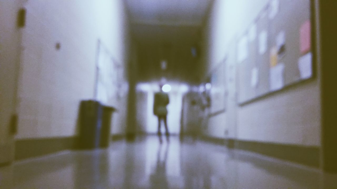 BLURRED MOTION OF WOMAN IN ILLUMINATED UNDERGROUND