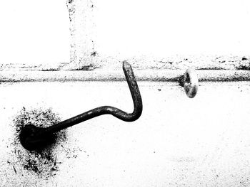 Close-up of barbed wire against wall