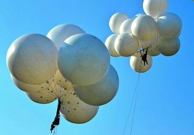 Balloons flying against clear sky