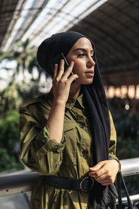 Portrait of young woman standing outdoors