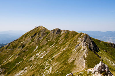 Scenic view of rocky mountains against clear sky in terminillo mountain, micigliano italy