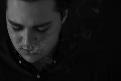 Close-up of young woman smoking