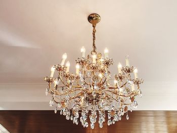 Low angle view of illuminated pendant lights hanging from ceiling