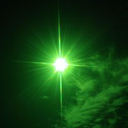 Low angle view of illuminated bright sun in sky