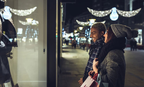 Young couple looking in shop window