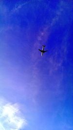 Low angle view of airplane flying in sky