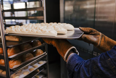 Cropped hands preparing pastry in bakery