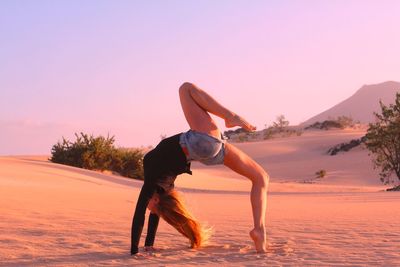 Full length of woman on beach during sunset