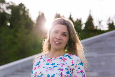 Portrait of smiling woman standing outdoors