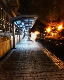 Illuminated walkway at night