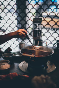 Person holding tea cup on table