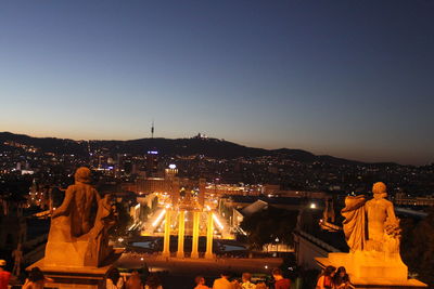 Statue in city at night