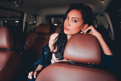 Young woman sitting in car