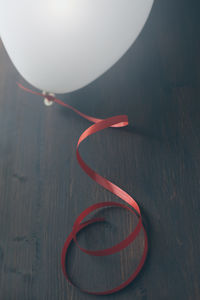 Close-up of ribbon tied to balloon on table