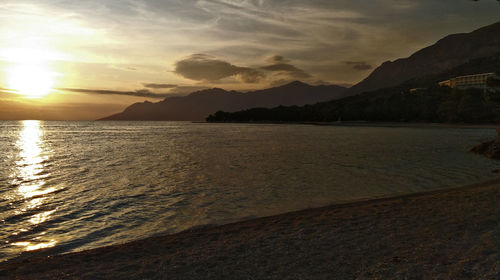 Scenic view of beach against sky during sunset