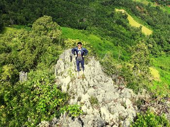 High angle view of hiker standing on mountain