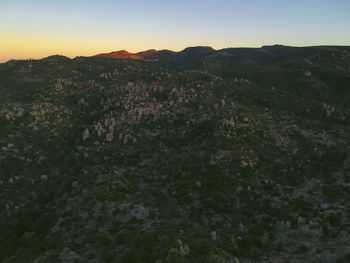 Scenic view of mountains against clear sky during sunset