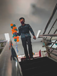 Low angle view of man standing against wall