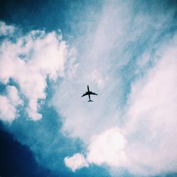 Low angle view of airplane flying in sky