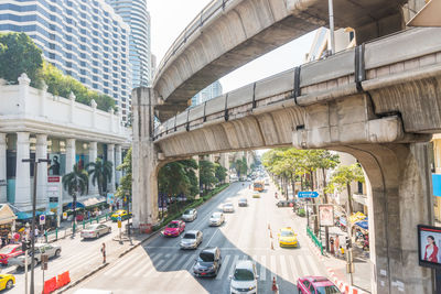 Traffic on road amidst buildings in city