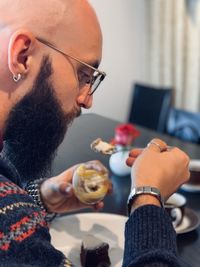 Beardedmen eating dessert