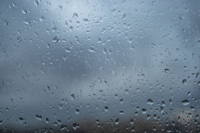 Full frame shot of raindrops on glass window