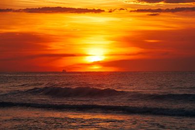 Scenic view of sea against orange sky