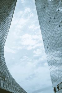 Low angle view of buildings against cloudy sky