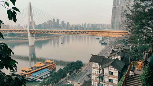 High angle view of bridge over river amidst buildings in city