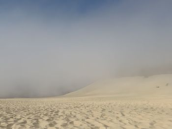 Scenic view of desert against sky during winter