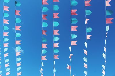 Full frame shot of multi colored flags against blue sky