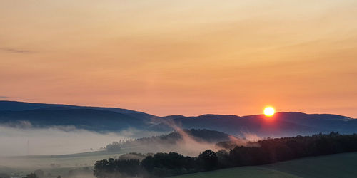 Scenic view of landscape against sky during sunset