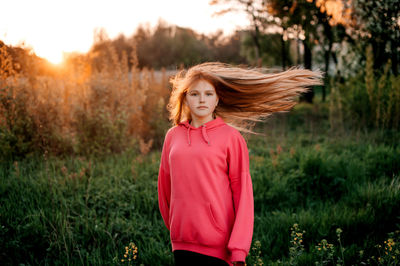 Young woman standing on field