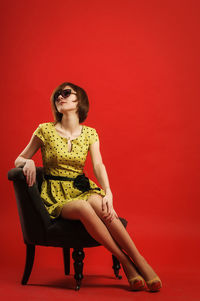 Woman sitting in a red man