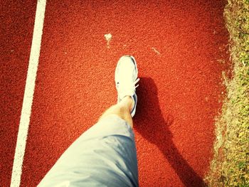 Low section of person standing on tiled floor