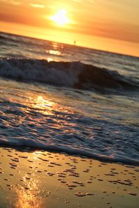 Scenic view of beach against sky during sunset