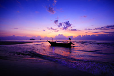 Boat in sea against sky during sunset