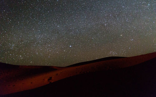 Scenic view of mountain against sky at night