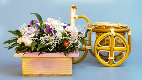 Close-up of yellow flower pot on table