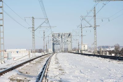 Railway tracks against clear sky during winter