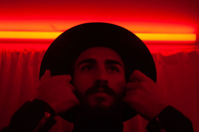 Portrait of man against orange sky