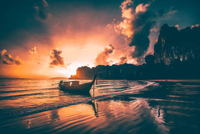 Silhouette of boat in sea against sky during sunset