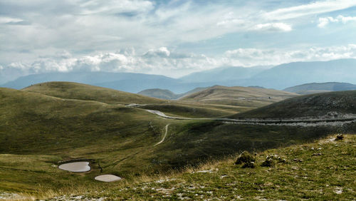 Dramatic landscape with mountain range in background