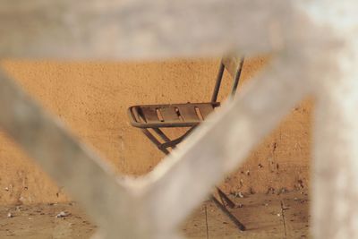 Close-up of metal fence against wall