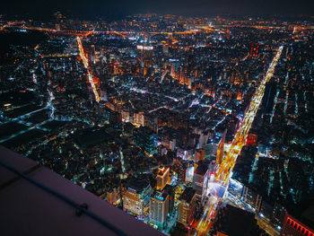 High angle view of city lit up at night