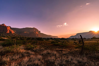 Scenic view of field against sky during sunset