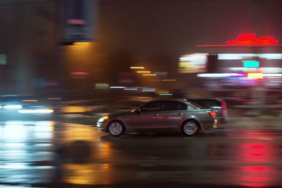 Blurred motion of car on road at night