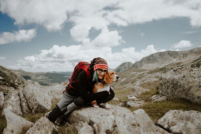 Man standing on rock against mountains