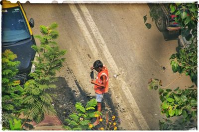 High angle view of man walking on road