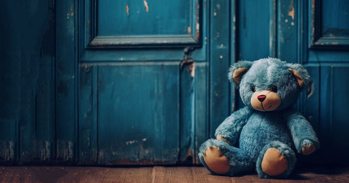 Teddy bear on wooden door